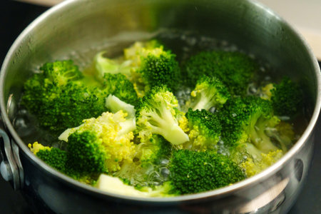 Cooking broccoli in boiling water for a healthy meal preparation in the kitchenの写真素材