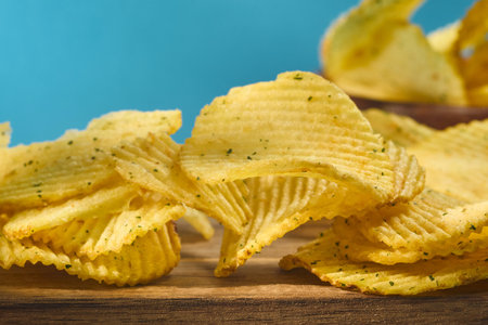 bowl holds a towering stack of crispy chips, showcasing their wavy texture and light seasoning