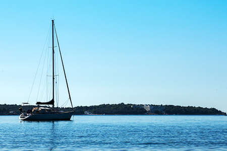 A boat on the sea with no clouds on horizonの写真素材