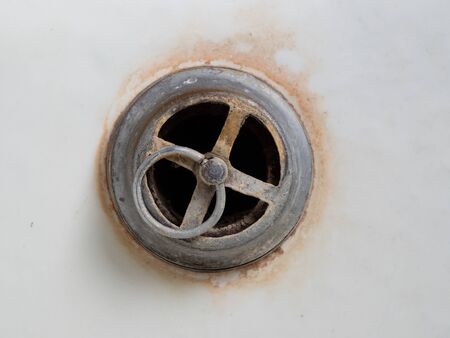 The overflow hole for the bathroom is covered with rust. Used plumbing in the house. The concept of...