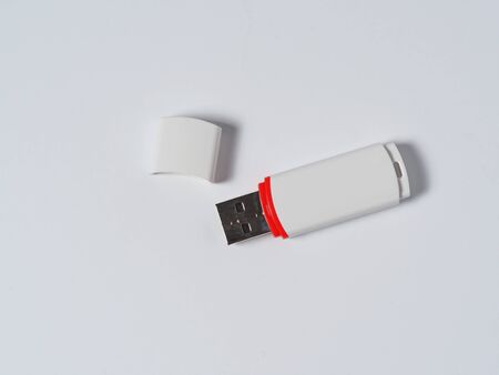 White usb flash drive isolated with a red stripe on the white background