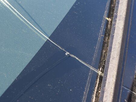 Crack on the car windscreen from a stone close-up.