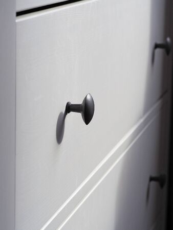 Part of a white modern wooden chest of drawersの写真素材