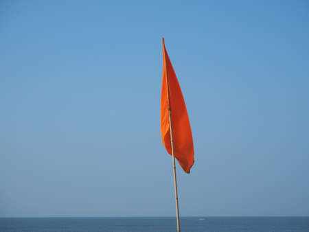 Red warning flag at the beach. Sign prohibiting swimming in this placeの写真素材