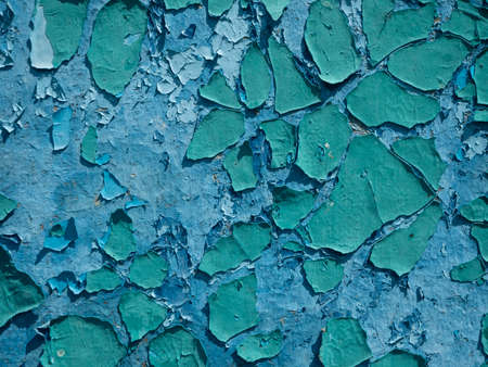 the old weathered peeling paint is blue on the wall. Close-up, background, textureの写真素材