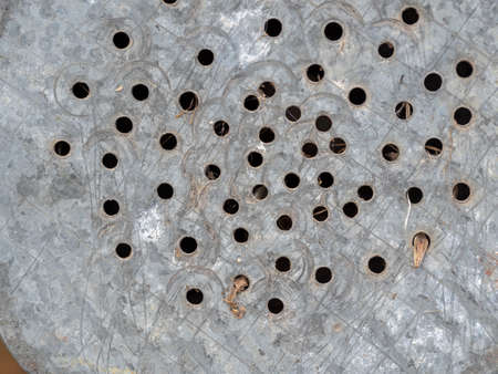 Dirty old iron watering can close-up. Metal backgroundの写真素材