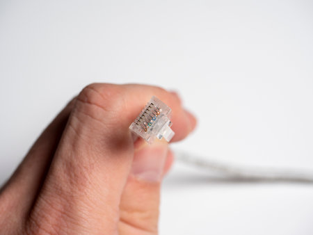 male hand holding communication cable patch cord rj45 on white background. Selective Focus