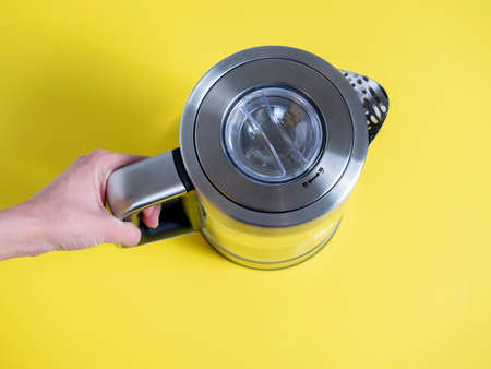 electric metal kettle in silver color with different modes of water heating on a bright yellow background.の写真素材
