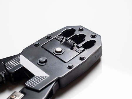 Crimping pliers for rj45 internet cables on a white background. Selective focus, copy space, tools...