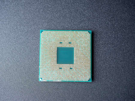 a computer processor with a lot of spoons on a dark background. Top view, flat lay. central...