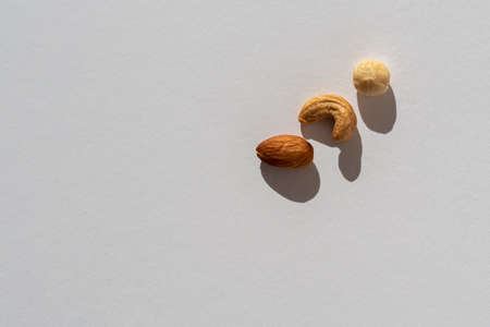 on a white background are almonds, cashews and hazelnuts. Copy space, a place for textの写真素材