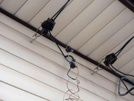 inserting electrical cables into a wooden house through the air with the help of piercing hermetic...