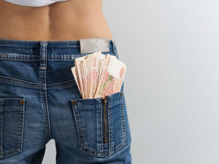 five thousand Russian rubles banknotes in the back pocket of his jeans. The concept of money in your pocket. Cash. Russian money, copy space, horizontal photoの写真素材