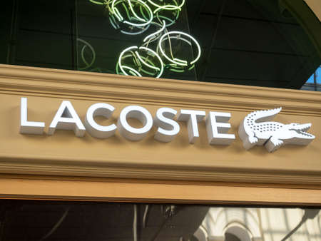 10.04.2021 Russia, Moscow. The sign of the company Lacoste. French clothing, footwear and...