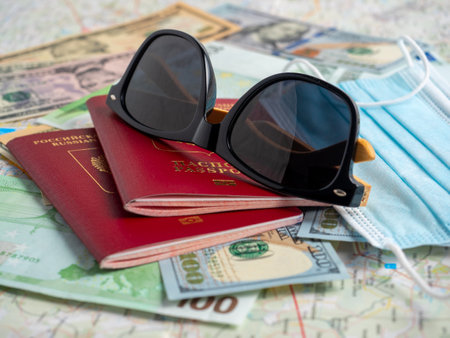 A close-up of a Russian passport with embedded dollar and EURO bills is on the map. The concept of travel and recreation.の写真素材