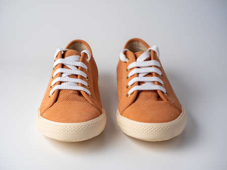 Front view of a pair of light brown sneakers standing on a white background. Studio shot. Leather, suedeの写真素材