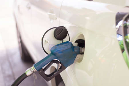 The car is fueled with gasoline at a gas station