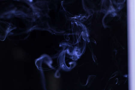 Blue Smoke on black background for art design or pattern.,Line abstract background., Smoke incense.,