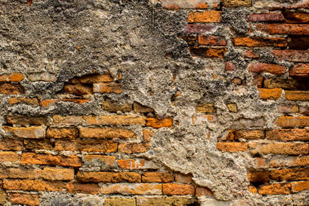 dimly lit old brick wall texture blackground.の写真素材