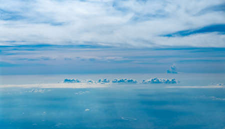 Clouds seen from an airplane, blue sunshine, soil background nature landscape