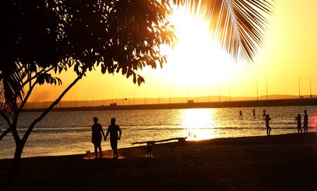 Beautiful sunset with couple of boyfriends in the background.の写真素材