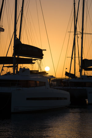Sailboats and yachts moored in a Caribbean Sea marina with a beautiful sunset in the background and beautiful sunsetsの写真素材