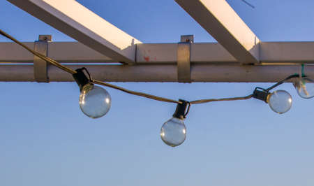 bulbs turned off for lighting on the outdoor terrace with sky in the backgroundの写真素材