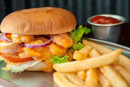 Shrimp burger with potato and black backgroundの写真素材