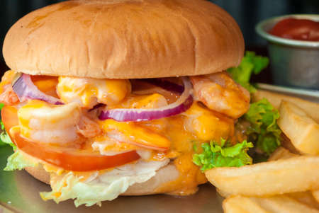 Shrimp burger with potato and black backgroundの写真素材