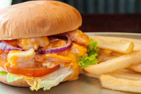 Shrimp burger with potato and black backgroundの写真素材