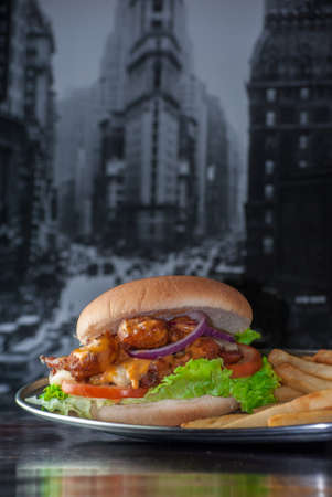 Shrimp burger tomatoes fries cheese and lettuceの写真素材