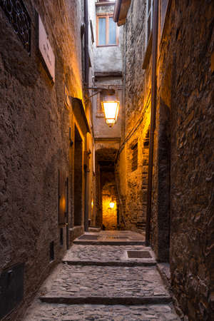 Ancient medieval street in town of Brienno-Lombardy, ComoLake. The evening, light up the lamps in the street that leads to the lakeのeditorial素材