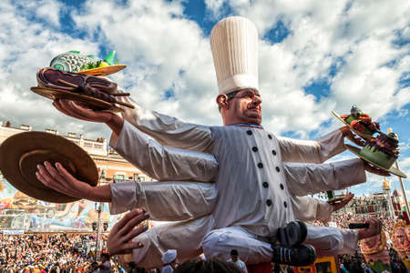 NICE - FRANCE - March 03, 2014: King of carnival 2014. The theme of Nice carnival is the gastronomy. A chef with more arms with different dishesのeditorial素材
