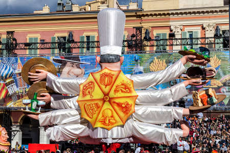 NICE - FRANCE - March 03, 2014: King of carnival 2014. The theme of Nice carnival is the gastronomy. A chef with more arms with different dishesのeditorial素材