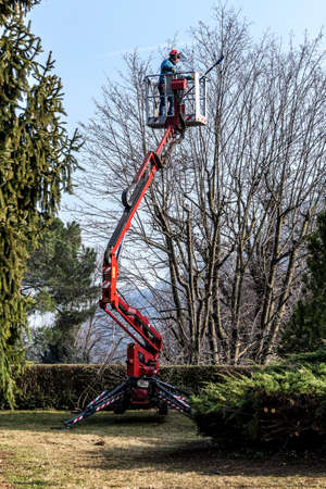 A gardener moves by his tracked basketの写真素材