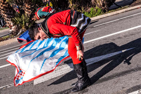 NICE - FRANCE - March 01, 2014: Carnival of Nice, Flowers' battle. This is the main winter event of the Riviera. Flag bearersのeditorial素材