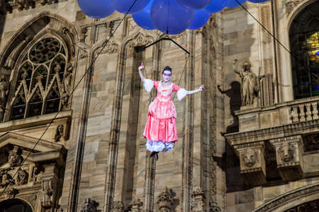 MILAN - ITALY - March 02, 2017: A company of acrobats actors inaugurate the Milan Carnival. In the background the Gothic Cathedral. Duomo square, Milan, Lombardy, Italyのeditorial素材