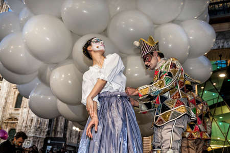 MILAN - ITALY - March 02, 2017: Harlequin Columbine helps to dress during Milan Carnival. Duomo Cathedral square, Milan, Lombardy, Italyのeditorial素材