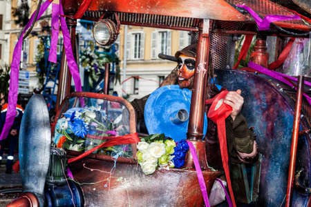 NICE - FRANCE - March 01, 2014: Carnival of Nice, Flowers' battle. A mask and a very special machineのeditorial素材
