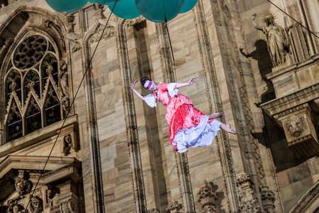 MILAN - ITALY - March 02, 2017: A company of acrobats actors inaugurate the Milan Carnival. In the background the Gothic Cathedral. Duomo square, Milan, Lombardy, Italyのeditorial素材