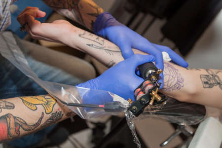 Como, ITALY - 17 May 2013.Tattoo machine and  sterilized nitrile gloves to make a beautiful tattoo. Como Lakeのeditorial素材