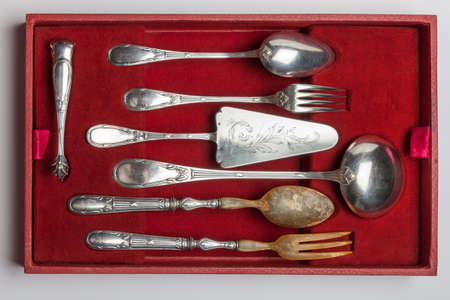 Vintage silverware in red velvet box isolated on white background, circa 1920の写真素材