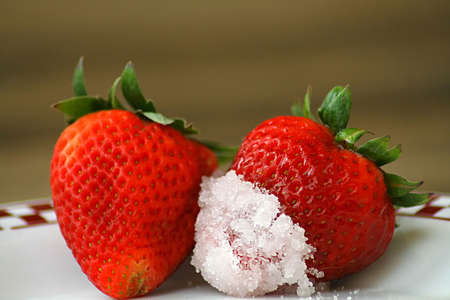 Strawberries dipped in sugarの写真素材