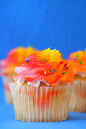 
close up of a cup cake on a blue background.の写真素材