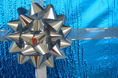 \r\ntextured metallic blue package with a metallic silver bow and silver ribbon.