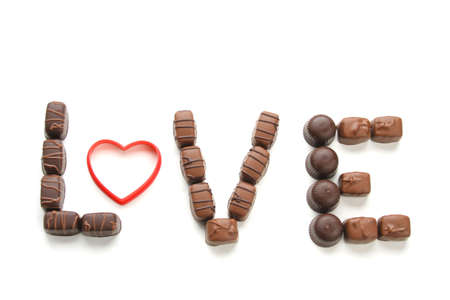 Chocolate candy spelling out the word love isolated on a white backgroundの写真素材