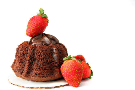 chocolate mini bunt cake with chocolate topping and strawberries all isolated on a white background.の写真素材