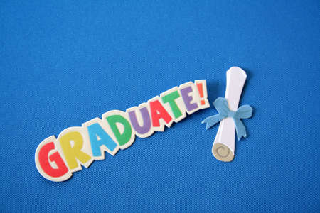 Colorful words that spell graduate on a blue background along with a diploma