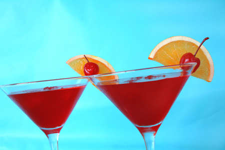 cocktails with orange and cherry garnish