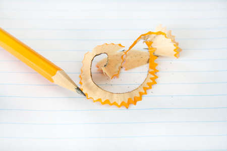 Pencil with shavings after being sharpened on a piece of notebook paper.の写真素材